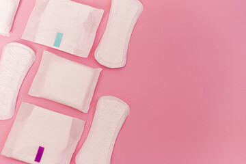 sanitary pads on a pink background. flat lay