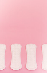 sanitary pads on a pink background. flat lay