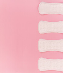 sanitary pads on a pink background. flat lay