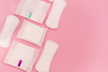 sanitary pads on a pink background. flat lay