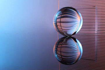 Transparent glass ball on mirror surface. Space for text