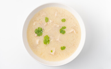 Georgian traditional chicken soup Chikhirtma in a white plate, flat lay on the white background