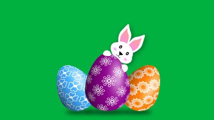 white bunny and three decorated eggs on green screen. concept for easter holiday.