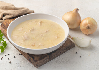 Chikhirtma - Georgian traditional soup made from chicken in a white plate