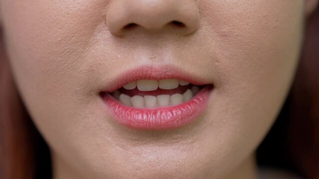 Close up shot of young women moves her lips talking with camera showing white straight healthy teeth, Lower part face detail of millennial woman speaker with beautiful teeth holding conversation