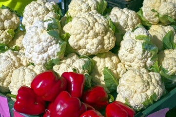 A Market Stall Adorned with Fresh Cauliflower and Vibrant Red Peppers: A Feast for the Senses