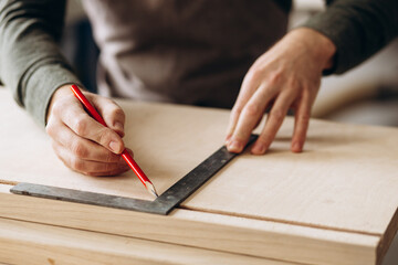 Carpenter measuring and working with wood