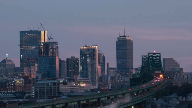 Time lapse of Boston skyline with bridge and express way over the cityscape day to night 