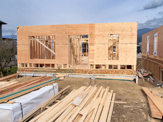 Fototapeta premium Wooden frame of a new house with engineered lumber materials in front
