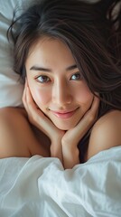 Naklejka premium a beautiful and happy young asian woman is relaxing in bed