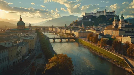 Zelfklevend Fotobehang Behold the majestic Freyschloessl Fortress standing proudly against the backdrop of Salzburg's skyline, its ancient stone walls bathed in warm sunlight © usama