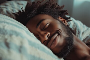 a handsome and happy young African man is relaxing in bed - obrazy, fototapety, plakaty