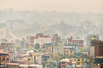 View of Kathmandu capital of Nepal from mountain through urban haze with lot of low rise buildings, cityscape creating an ethereal atmosphere in mountain air, Kathmandu air pollution