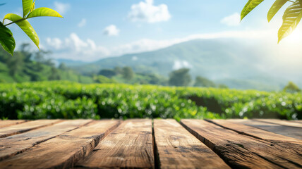 Empty wooden table top with blurred tea plantation landscape against blue sky and blurred green leaf frame Product display concept natural background - obrazy, fototapety, plakaty