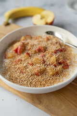 Gluten free breakfast yogurt with puffed amaranth, bananas and apples