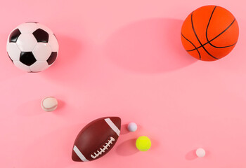Many different sports balls on pink background, flat lay. Space for text - obrazy, fototapety, plakaty