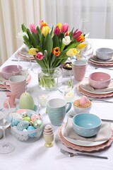 Festive table setting with beautiful flowers. Easter celebration