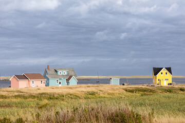 The colourful houses and fishing boats of Havre Aubert, Magdalen Islands, on the gulf of St Lawrence in Canada.