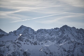 Drone shots at Herzogstand in Bavaria near the Alps, with snow-covered mountains, lakes and landscapes in the background