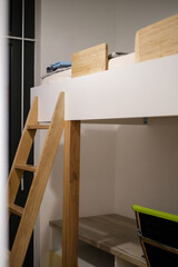 Classic white bunk bed with a wooden slat ladder, perfect for siblings or small spaces
