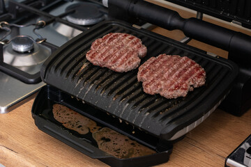 Juicy beef patty for burgers on a hot grill