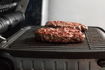 Freshly grilled burger meat. Burgers on the grill. Cooking burgers on hot grill