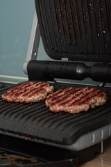 Juicy beef patty for burgers on a hot grill
