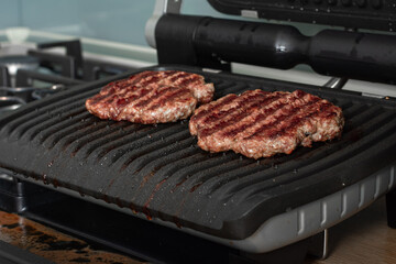 Freshly grilled burger meat. Burgers on the grill. Cooking burgers on hot grill