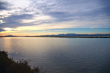 Sunset over saline lakes with Tamarit watchtower near Santa Pola, Spain, Europe