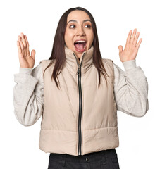 Modern young Caucasian woman portrait on studio background celebrating a victory or success, he is surprised and shocked.