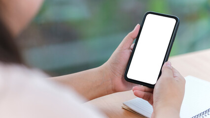 Close up view woman holding smart phone with empty screen for your text message or information content.