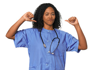 African American nurse in studio background feels proud and self confident, example to follow.
