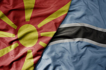 big waving national colorful flag of botswana and national flag of macedonia .