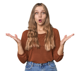 Studio portrait of a blonde Caucasian woman surprised and shocked.