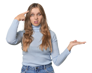 Studio portrait of a blonde Caucasian woman holding and showing a product on hand.