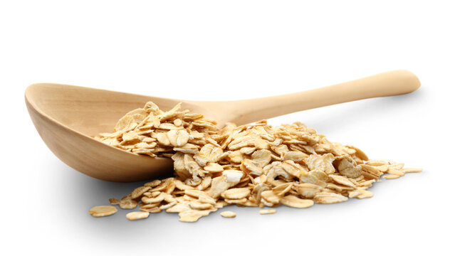 Heap of rolled oats with wooden spoon