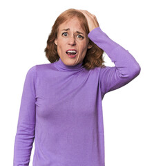 Redhead mid-aged Caucasian woman in studio being shocked, she has remembered important meeting.