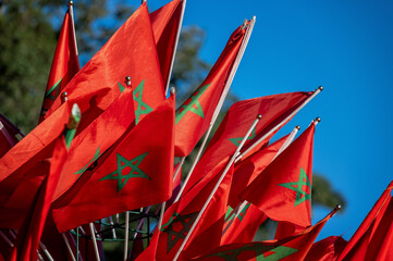 Closeup view of numerous Moroccan flags blowing in the wind in Marrakesh, Morocco