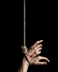 Woman hands with bloody stains tied with a rope over black background. Hostage - obrazy, fototapety, plakaty