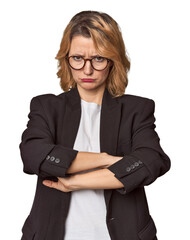 Caucasian woman in black business suit unhappy looking in camera with sarcastic expression.