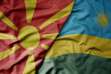 big waving national colorful flag of rwanda and national flag of macedonia .