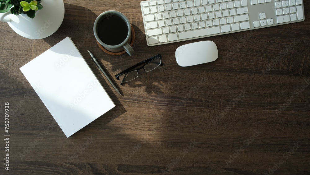 Canvas Prints simple workplace notebook, coffee cup and wireless keyboard on wooden table. top view..