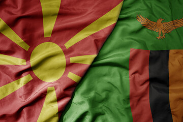 big waving national colorful flag of zambia and national flag of macedonia .