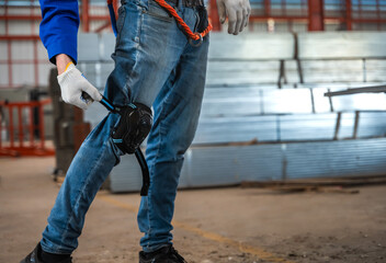 Close up factory worker man wearing protective knee pads in warehouse workplace