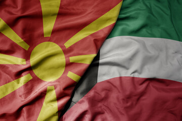 big waving national colorful flag of kuwait and national flag of macedonia .