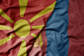 big waving national colorful flag of mongolia and national flag of macedonia .