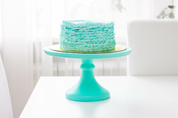 Exquisite birthday Cake Decorated with Green and turquoise Fondant Ruffles on white background