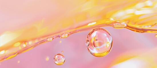Moisturizer Clear Oil Bubble flothing under thin layer of oil and water in vibrant color ful pink and yellow rose gold background
