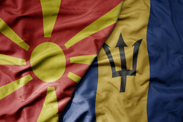 big waving national colorful flag of barbados and national flag of macedonia .
