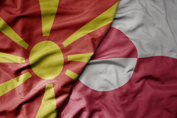 big waving national colorful flag of greenland and national flag of macedonia .
